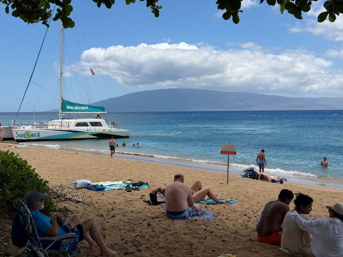 A catamaran boat pulled up to the shore of Kaanapali Beach on Maui.