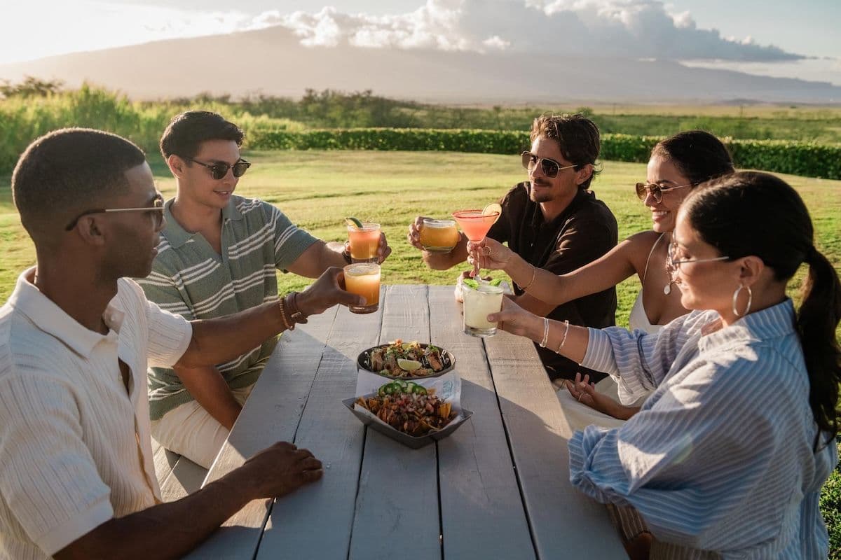 Friends having cocktails outside at Ocean Vodka Organic Farm and Distillery, Kula, Maui.