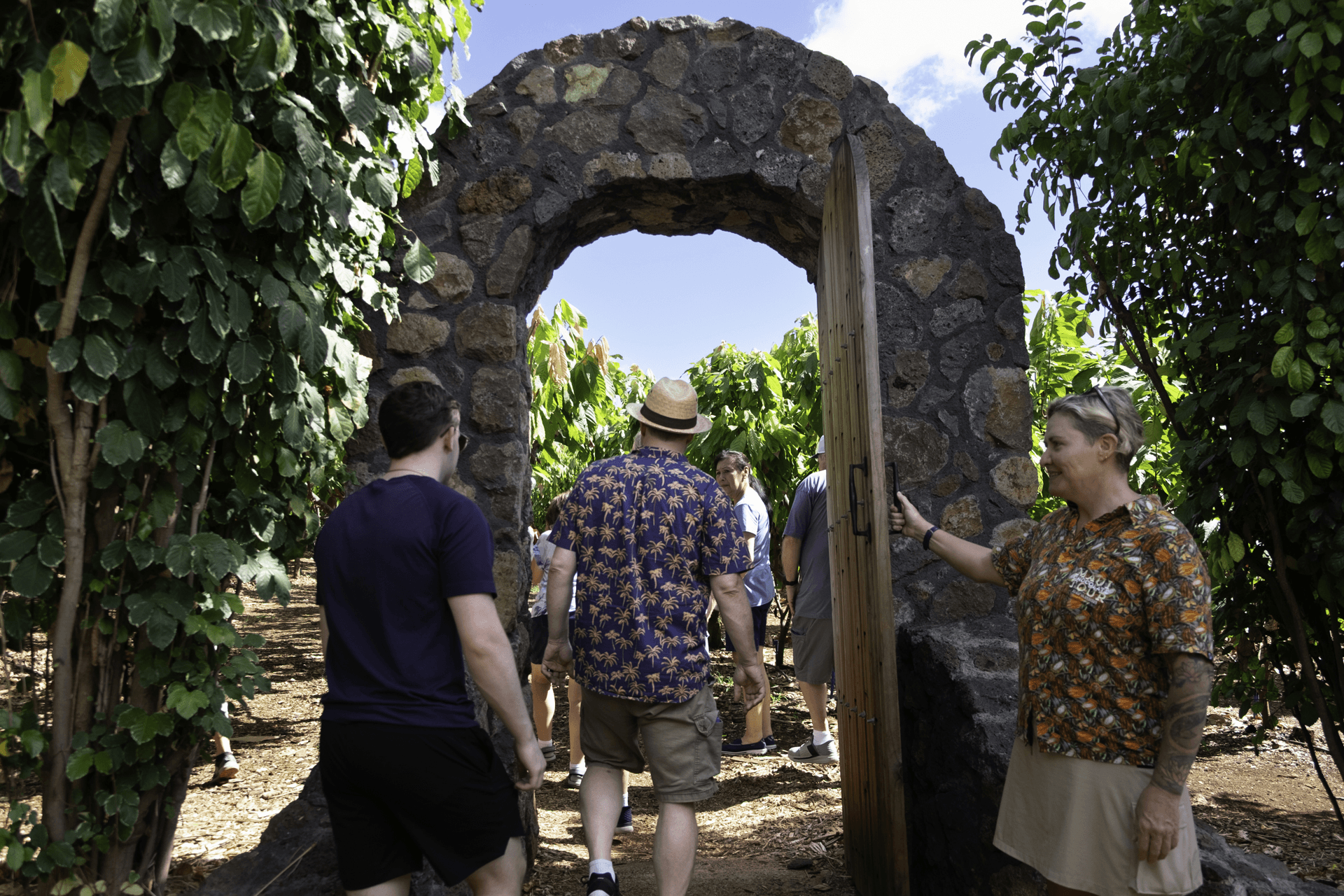 Farm tour guide Kerry Glen welcomes guests into the cacao orchard at Kuʻia Estate. Photo by Sarah Burchard.