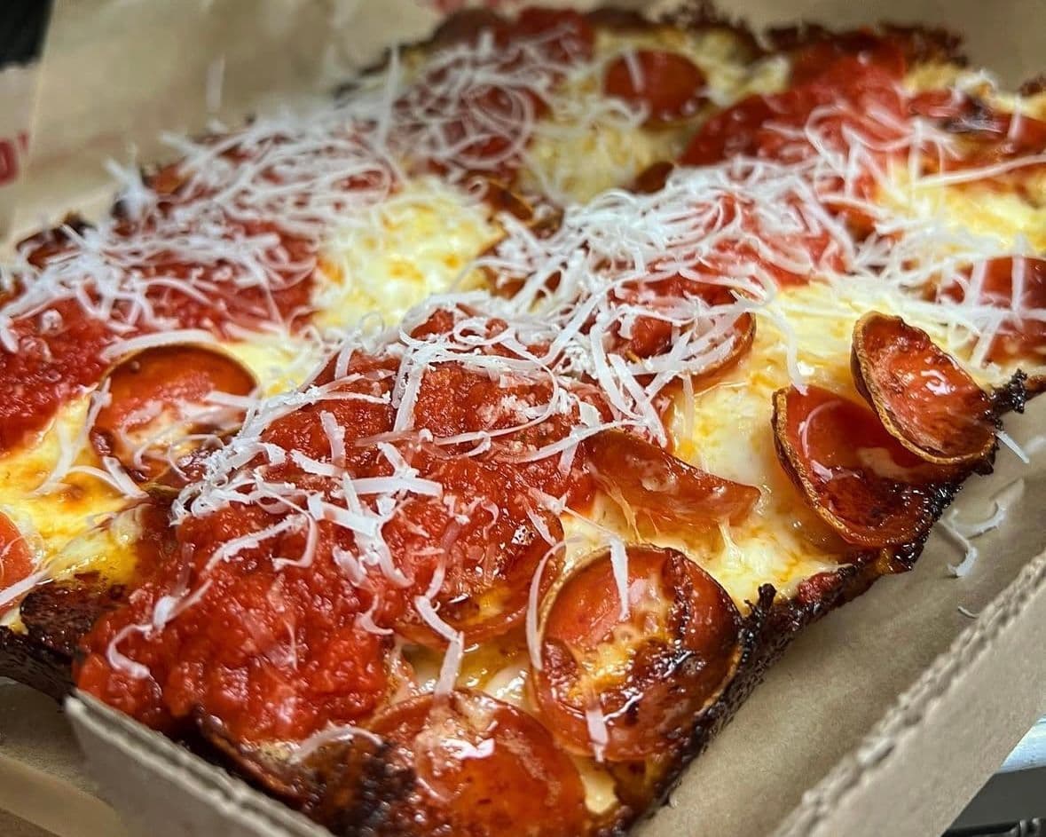Thick pepperoni pizza with parmesan shredded on top