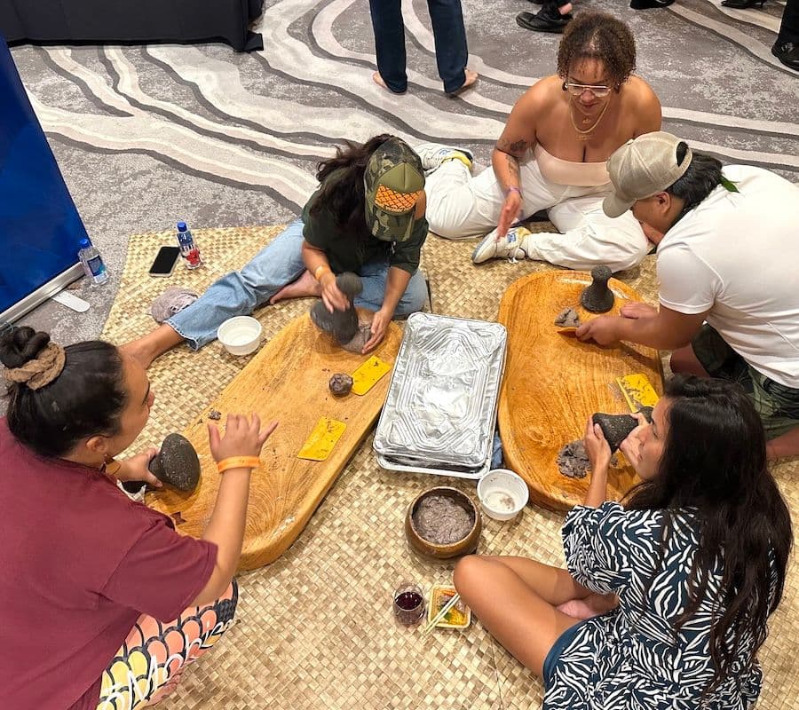 Poi pounding demonstration at Hawaii Food & Wine Festival 2024 on Oʻahu. Photo by Sarah Burchard.