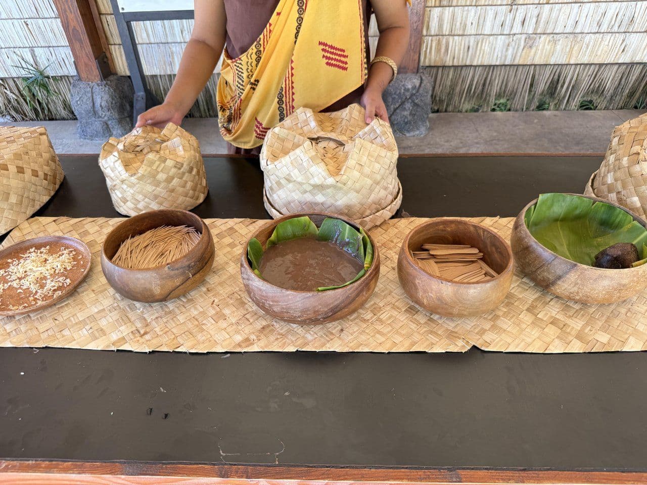 Man displaying bowls of poi