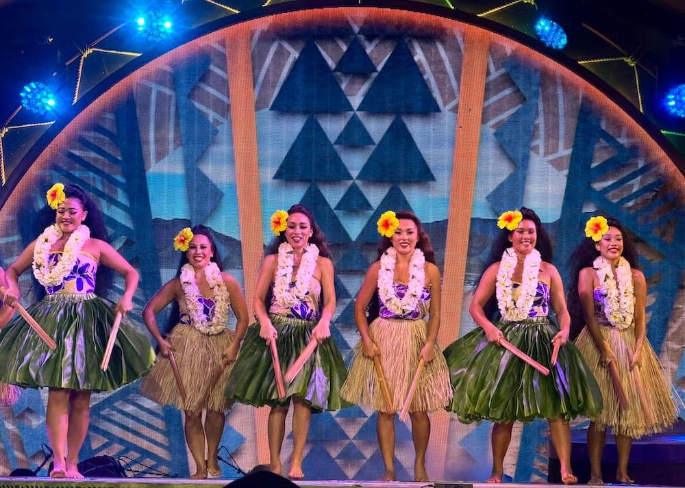 Female hula dancers performing on stage on oahu hawaii.