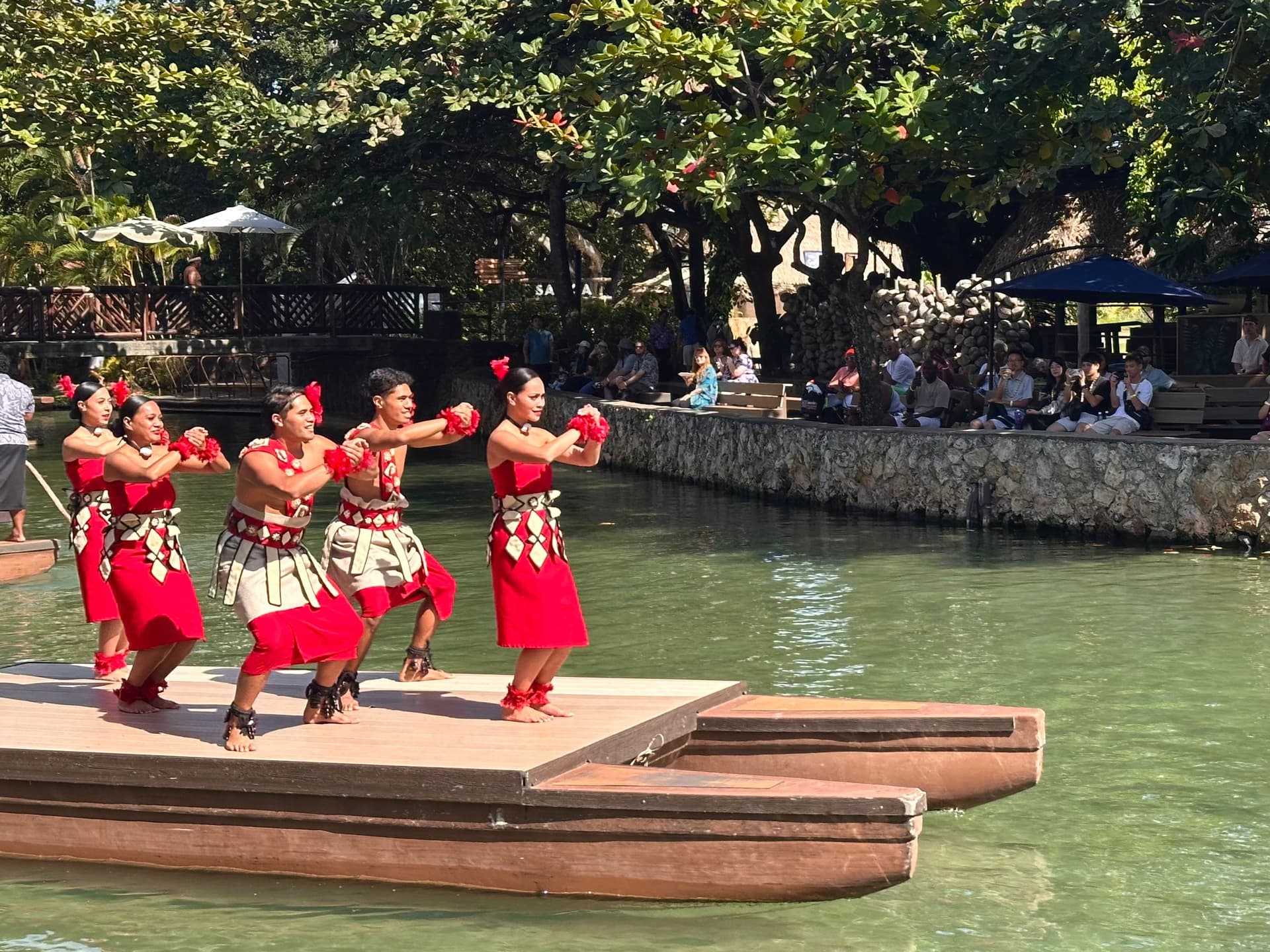 hula dancers floating on a canoe