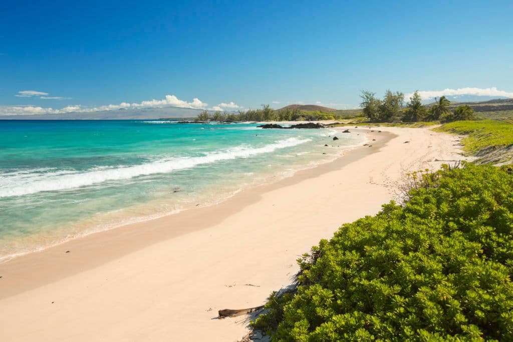 Makalawena Beach on the Big Island, a beautiful remote white sand beach and turquoise water. (Photo: Getty Images)