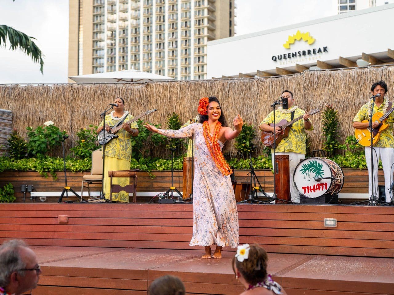 Woman dancing hula at a luau in waikiki oahu.