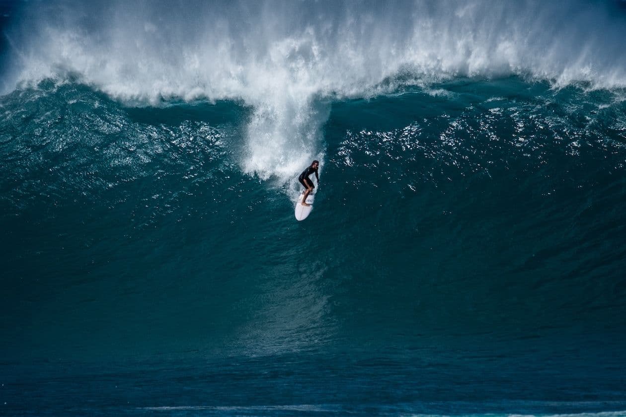 big wave surfing on oahu at banzai pipeline.