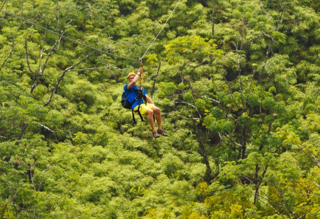 Man on Zipline over Lush Tropical Valleyhateii hawiia hawaii. hawaiii hawiaii hwaii hawaai hawall hawii hawwai hawwaii hawwii hiwaii haiwaii hawia hawwi 158192807