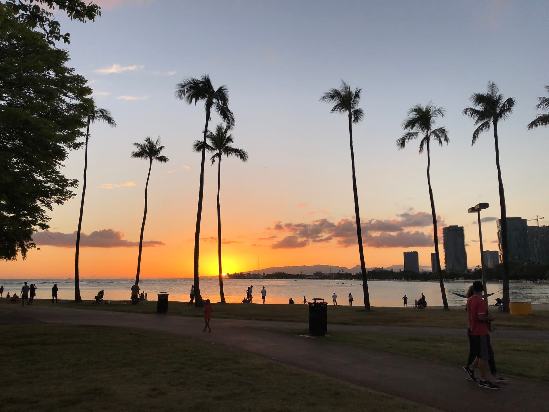 Sunset over the ocean at magic island in honolulu oahu hawaii.