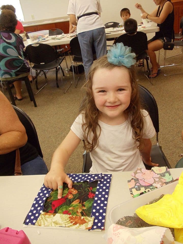 Julia Goodrich displays her crazy quilt. Photo: Susan Hogan.