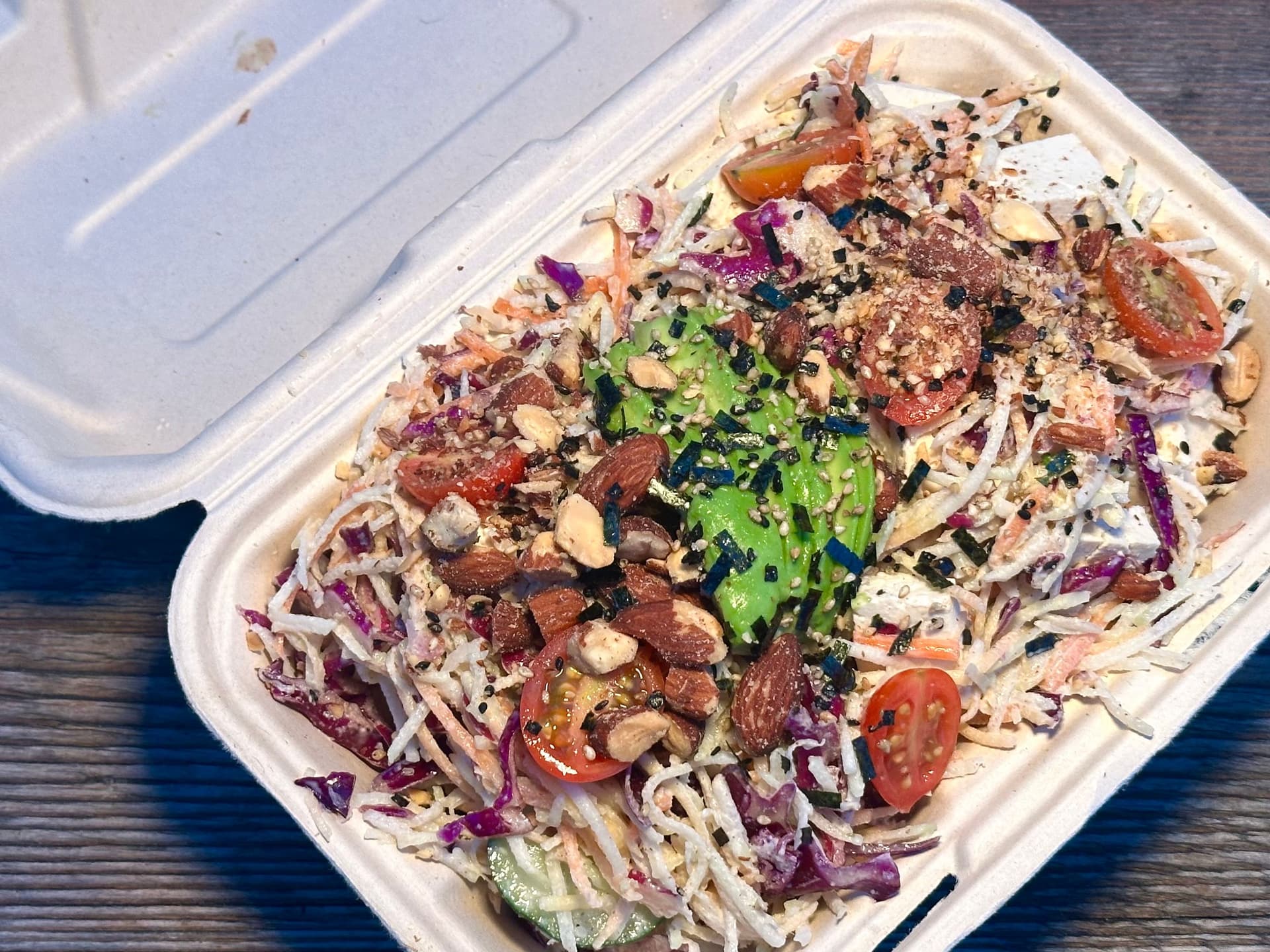 salad with shredded cabbage, avocado, almonds and carrots.