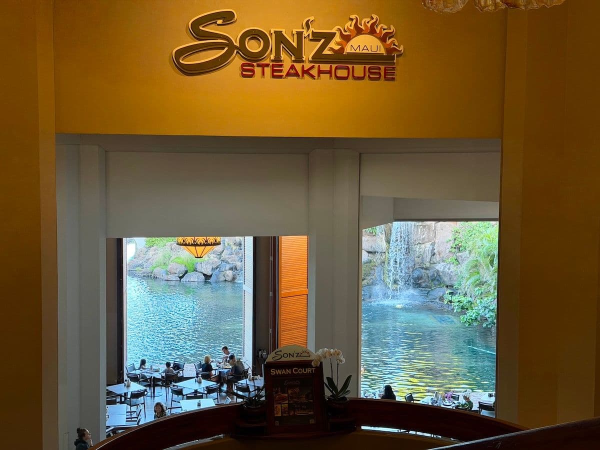 The exterior of Son'z Steakhouse with waterfall and lagoon view at Hyatt Maui in Hawaii.