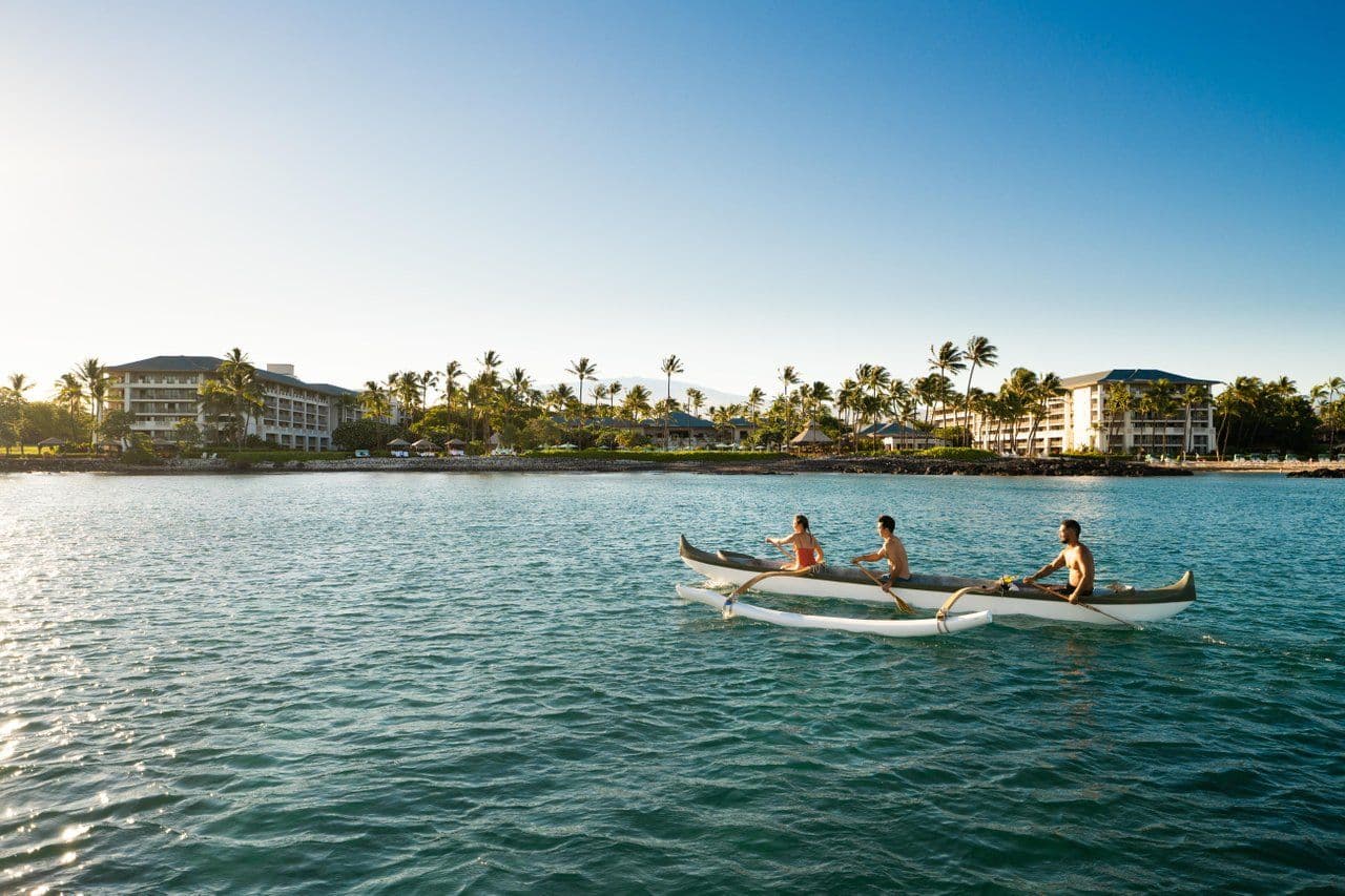 paddling in a canoe on the ocean during sunrise