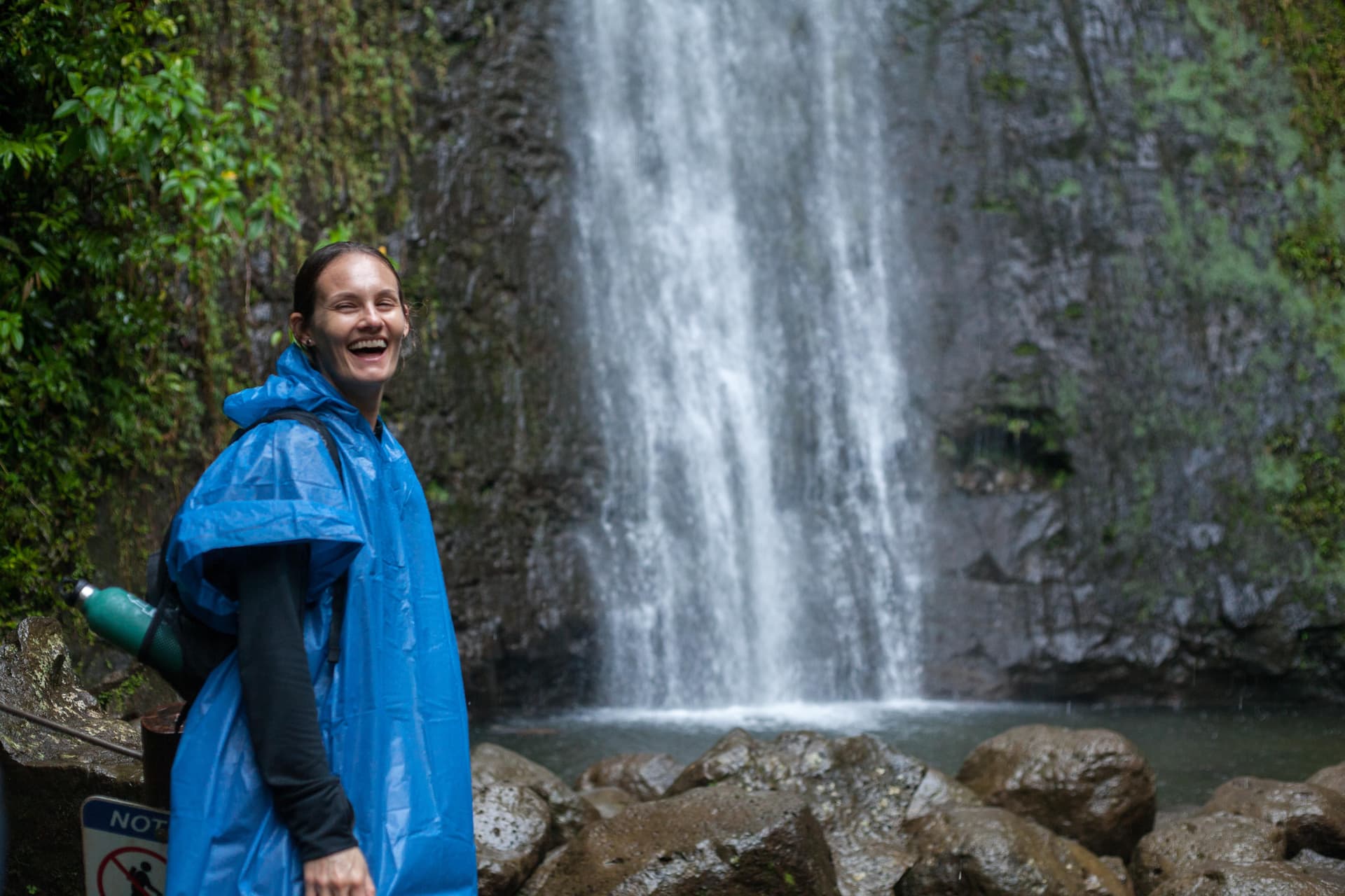 Woman standing in front of a waterfall