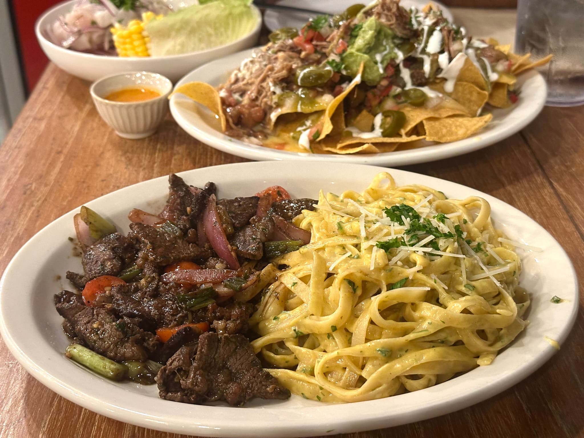 Steak and Noodles, nachos and ceviche at Ochos 888. Photo by Sarah Burchard.