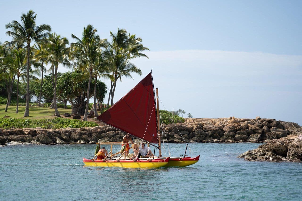 Friends sailing in an outrigger canoe on Oahu Hawaii.