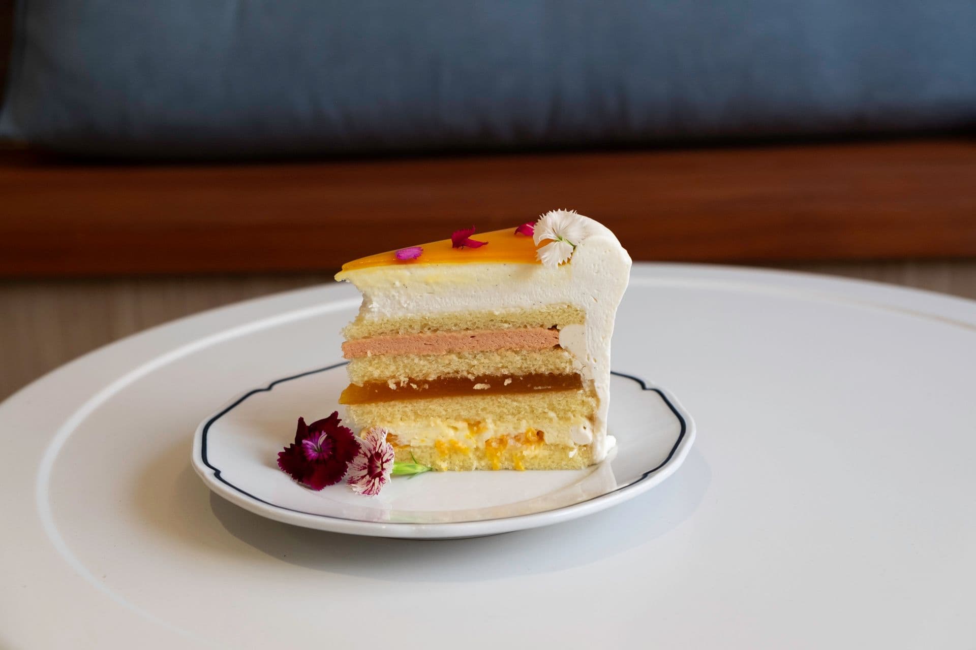 Slice of cake on a plate with blue background