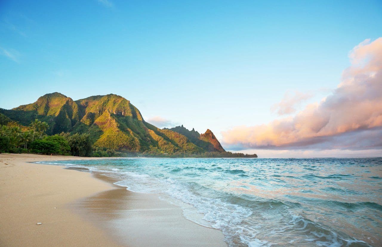 beach with mountain view and turquoise water on kauai