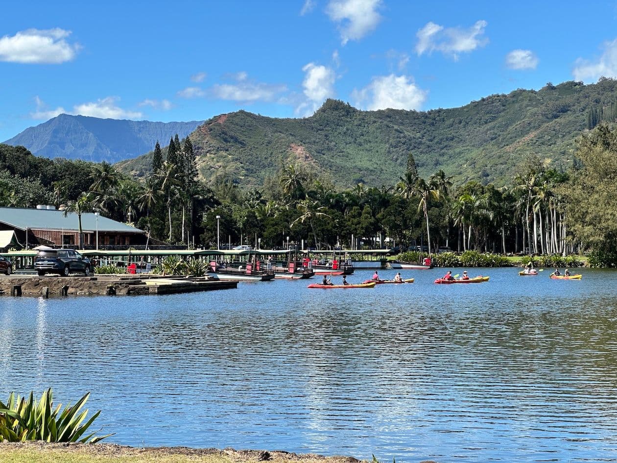 People kayaking at the boat and kayak launch near the mouth of Wailua River on Kauai, Hawaii.