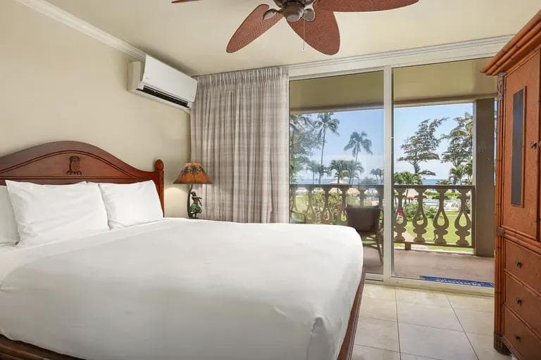 A couple lounging by a beachfront pool in Hawaii.