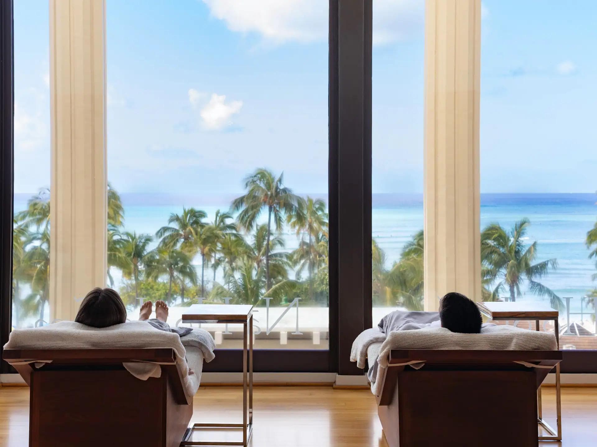 Two people relaxing at an oceanfront day spa.