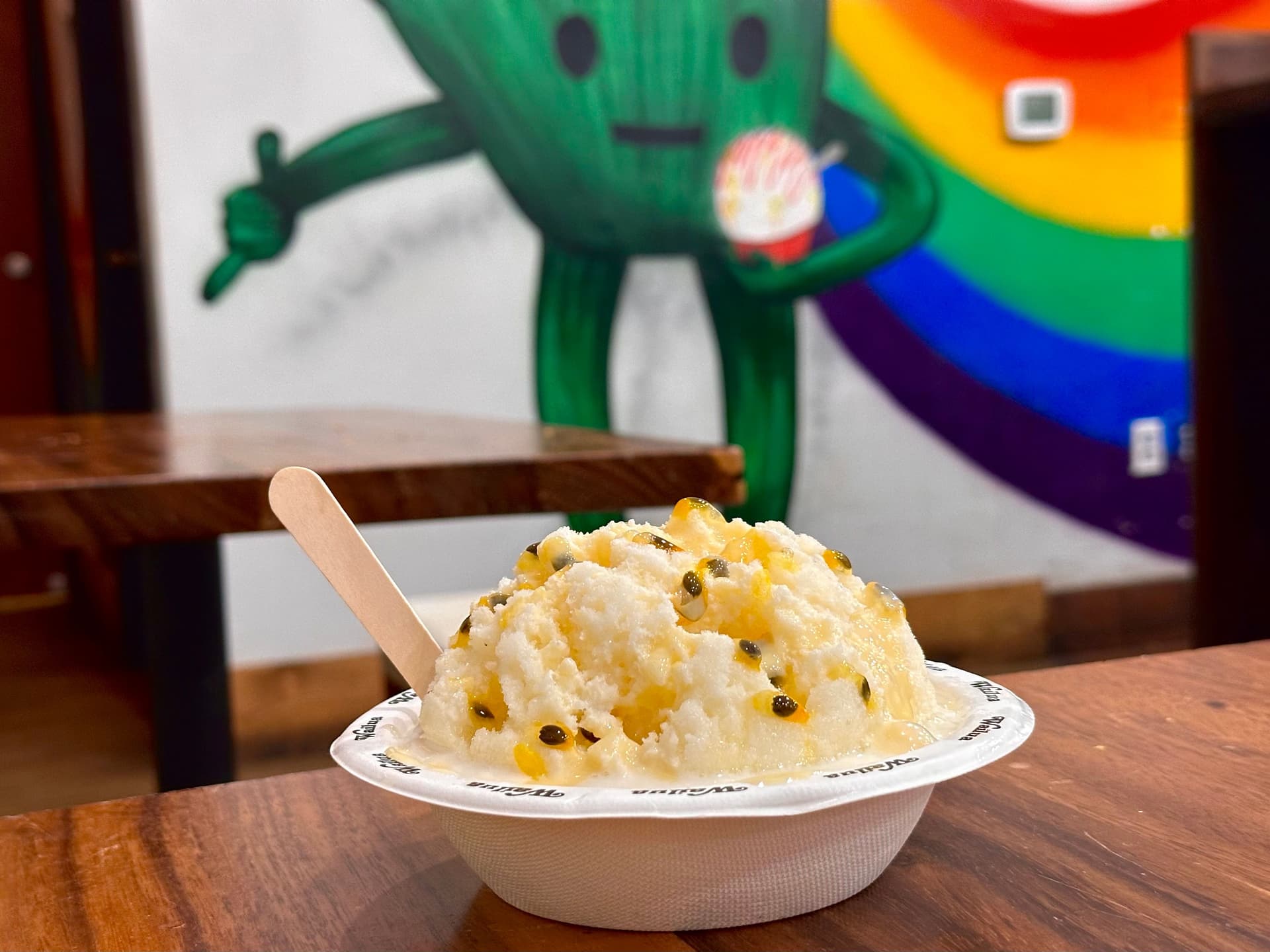 Shave ice topped with lilikoi and condensed milk at famous spot in Kauai.
