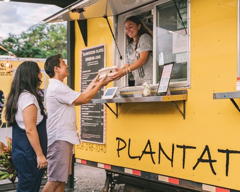 People ordering food at a food truck.