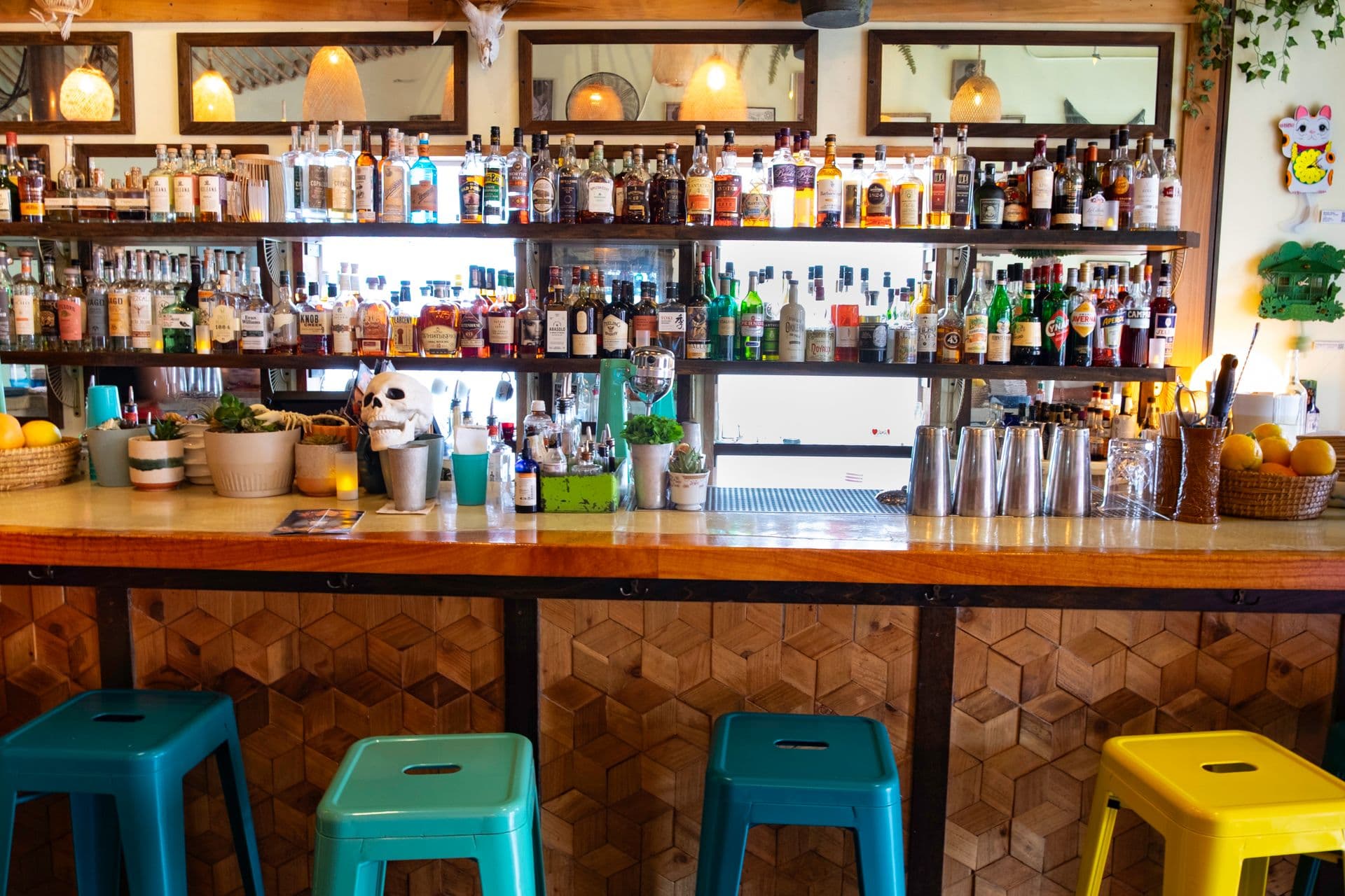 A cocktail bar with colorful bar stools.