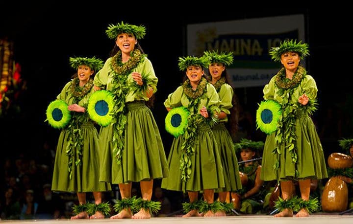 The wahine from Halau Hula 'O Kahikilaulani (Kumu Hula Nahokuokalani Gaspang; Hilo, HI) dance during the Kahiko portion of the Merrie Monarch Festival competition. Photo: Dennis Oda.