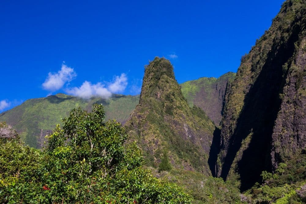 A lush green landscape of Iao Needle at Iao Valley State Park in Wailuku Hawaii.