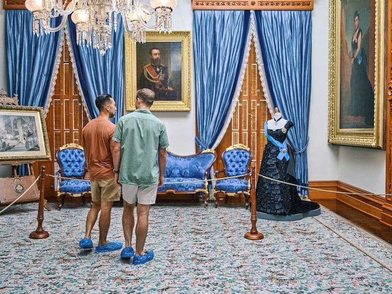 Two men touring ʻIolani Palace in Honolulu Oahu.