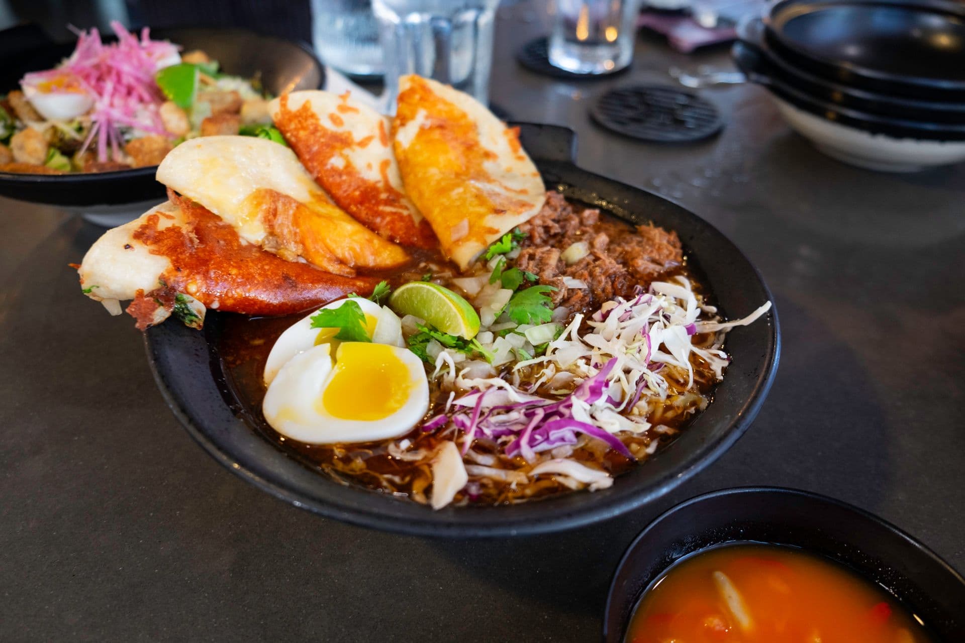 A bowl of ramen with four tacos at Coco Deck restaurant in Lahaina Maui Hawaii.