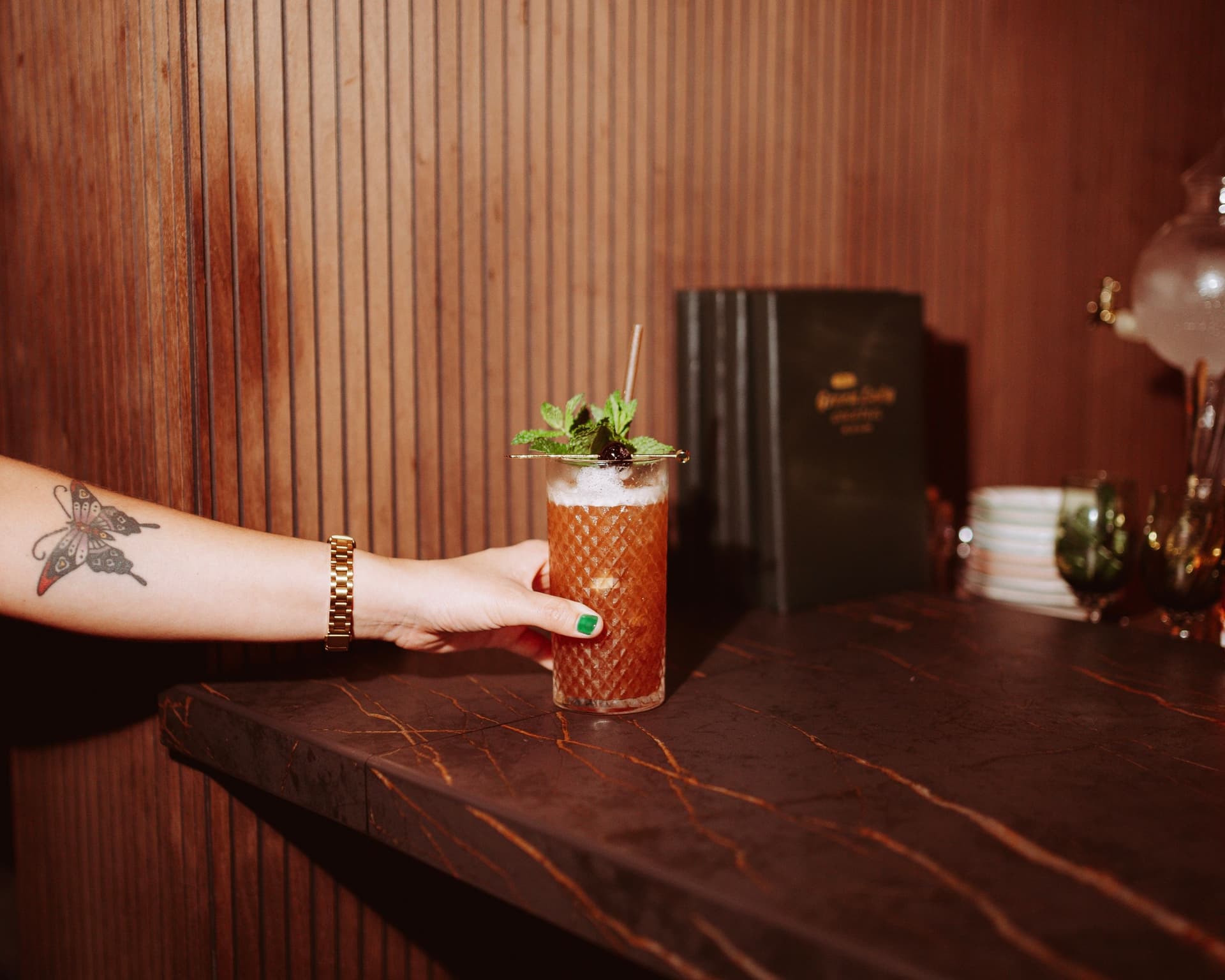 A woman's hand holding a cocktail.