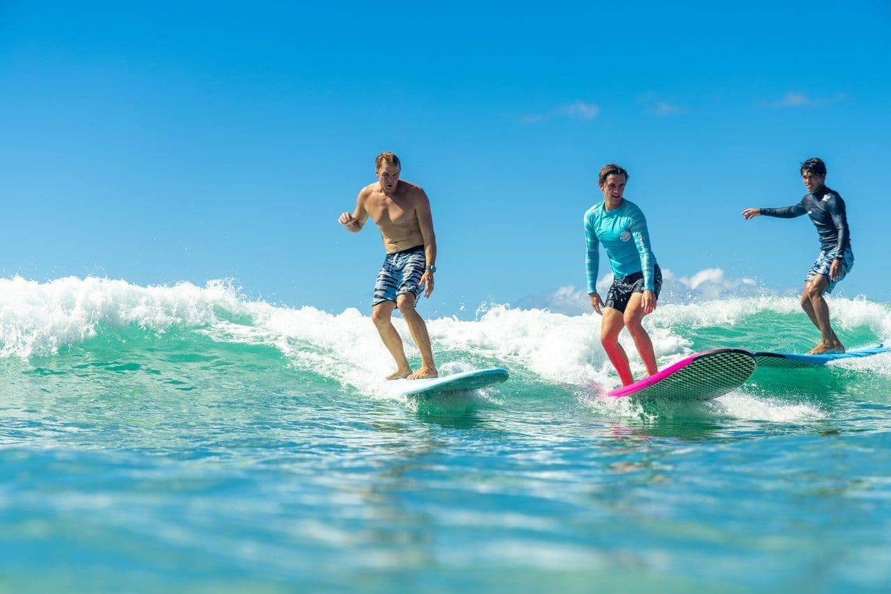 Tourists surfing in hawaii.