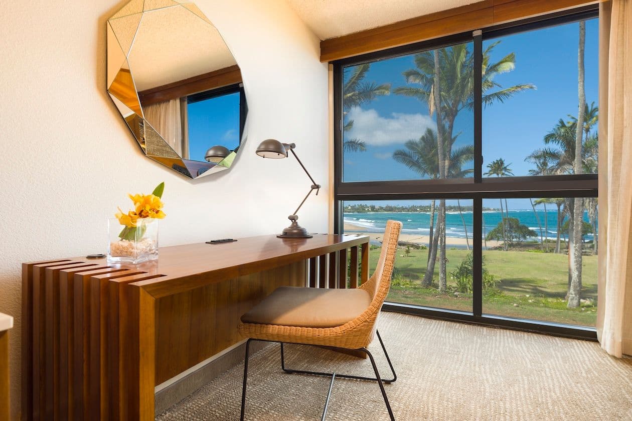Ocean view hotel room desk and chair.