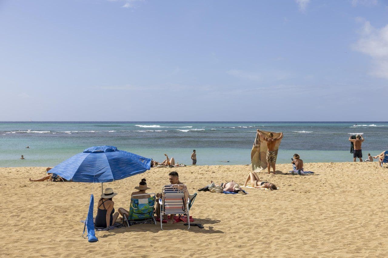 Families enjoying time at the beach in Hawaii.