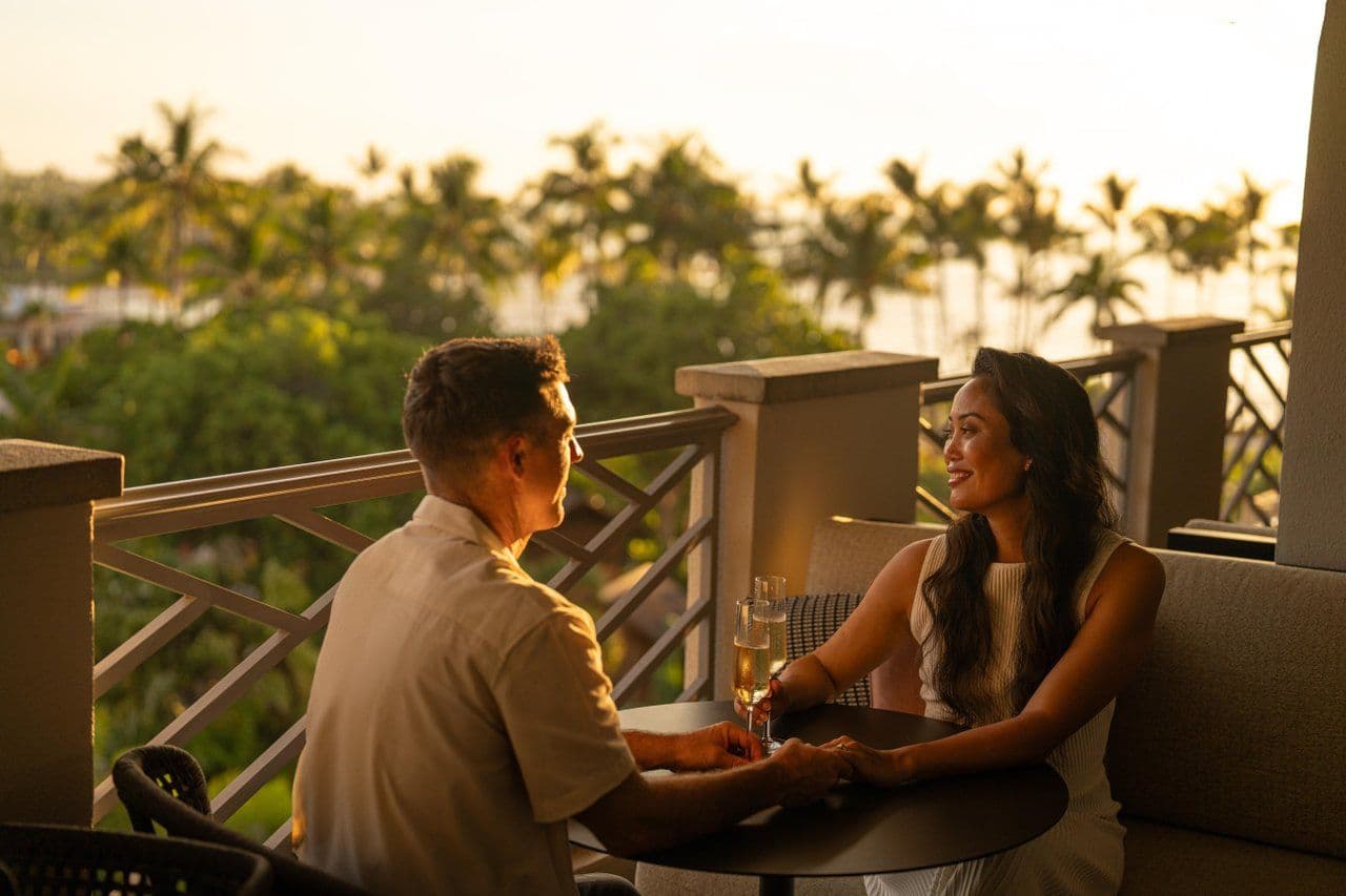 A couple dining outdoors with ocean in background