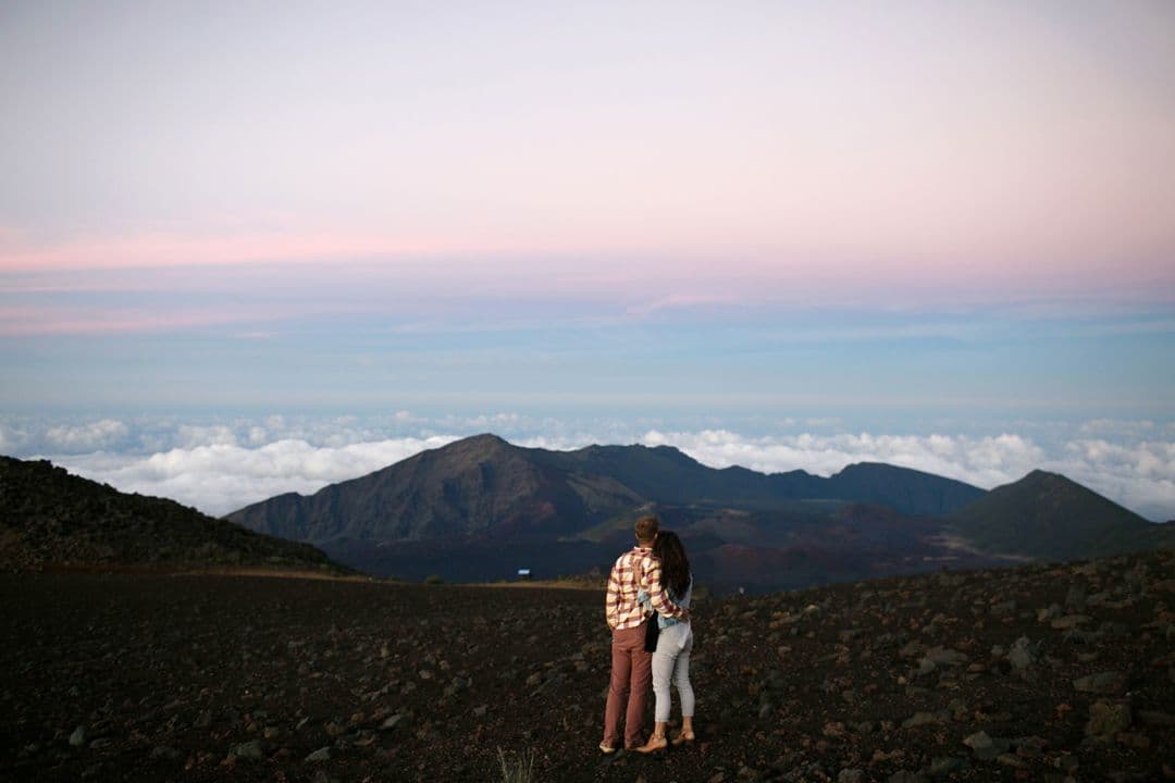 A couple standing at the summit of Haleakala on Maui.