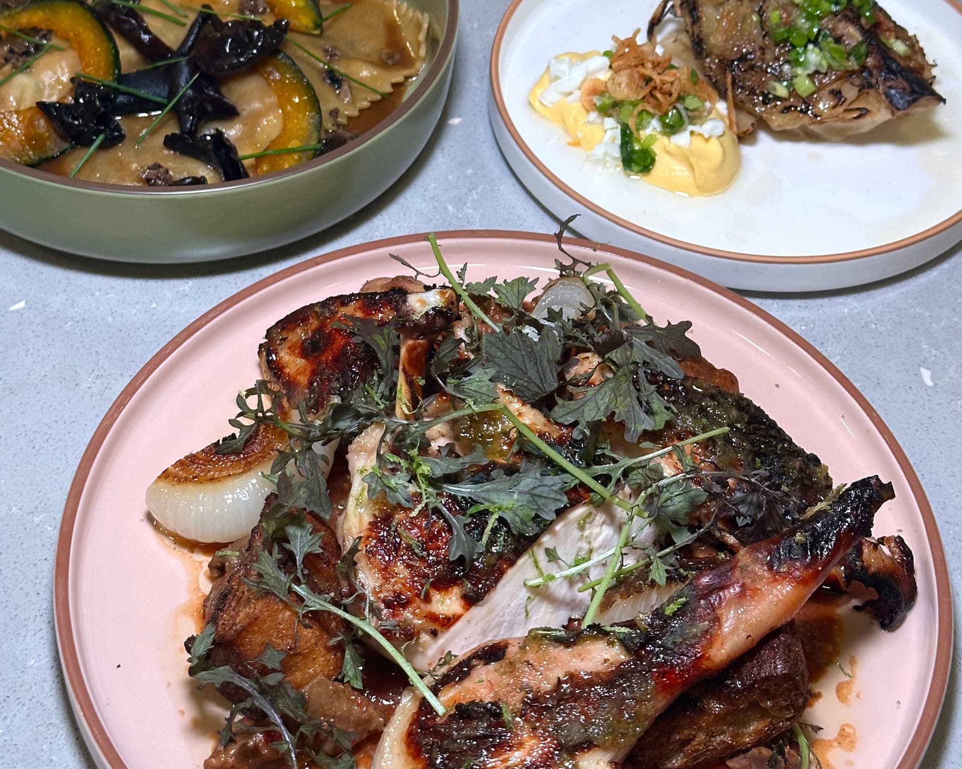 Roasted chicken on a pink plate.