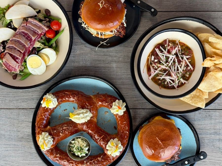 Birdseye view of soft pretzel, burgers, salad, poke and chips at Lahaina Brewing Co on Maui Hawaii.
