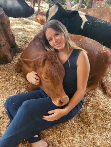 Woman cuddles cow at Krishna Cow Sanctuary