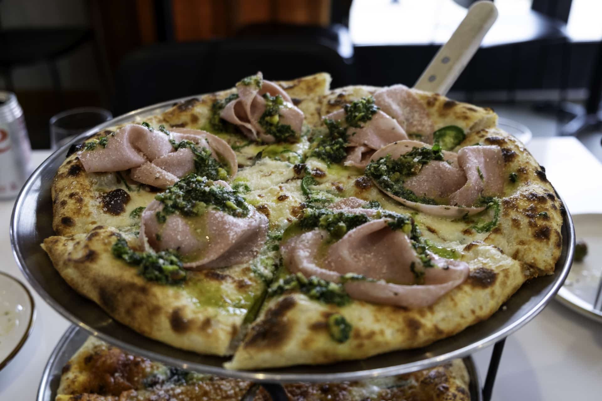 Mortadella "white pie" with mozzarella, jalapeno and pistachio pesto at Marlow.