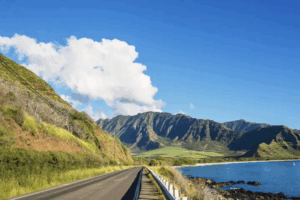 road with mountains and ocean in background